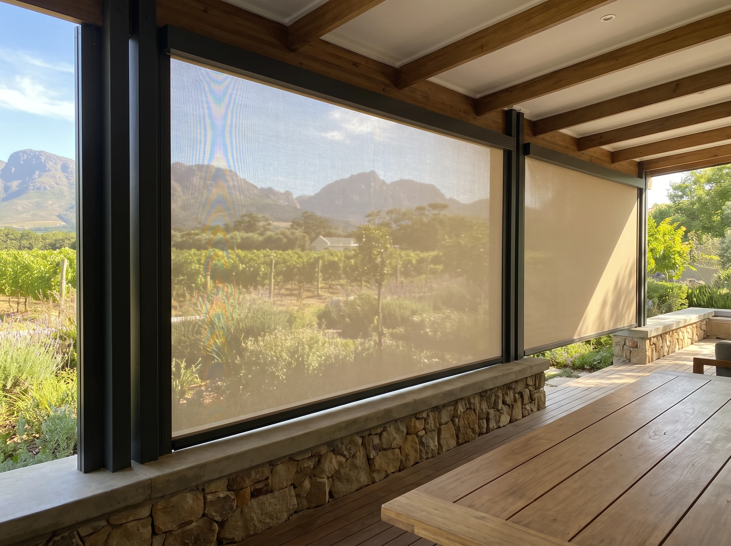 Zip-track outdoor screen enclosing a covered terrace with sunscreen mesh in a Cape Winelands estate home